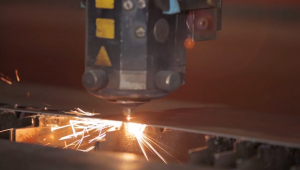 CNC Lazer Machiine cutting steel with sparks flying out
